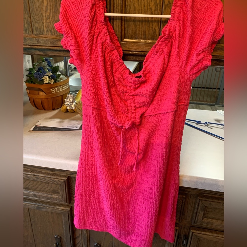 Vibrant Pink Textured mini dress off shoulder and peek a boo hole in center.
